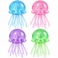 Four Glitter Jellyfish Squishy toys in blue pink purple and green with sparkling translucent heads and soft dangling tentacles on white background